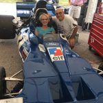 Larry and Roxane Bakerjian try out a Formula One race car.