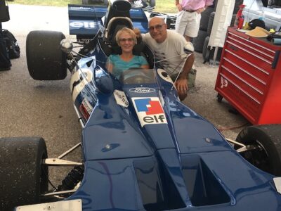 Larry and Roxane Bakerjian try out a Formula One race car.
