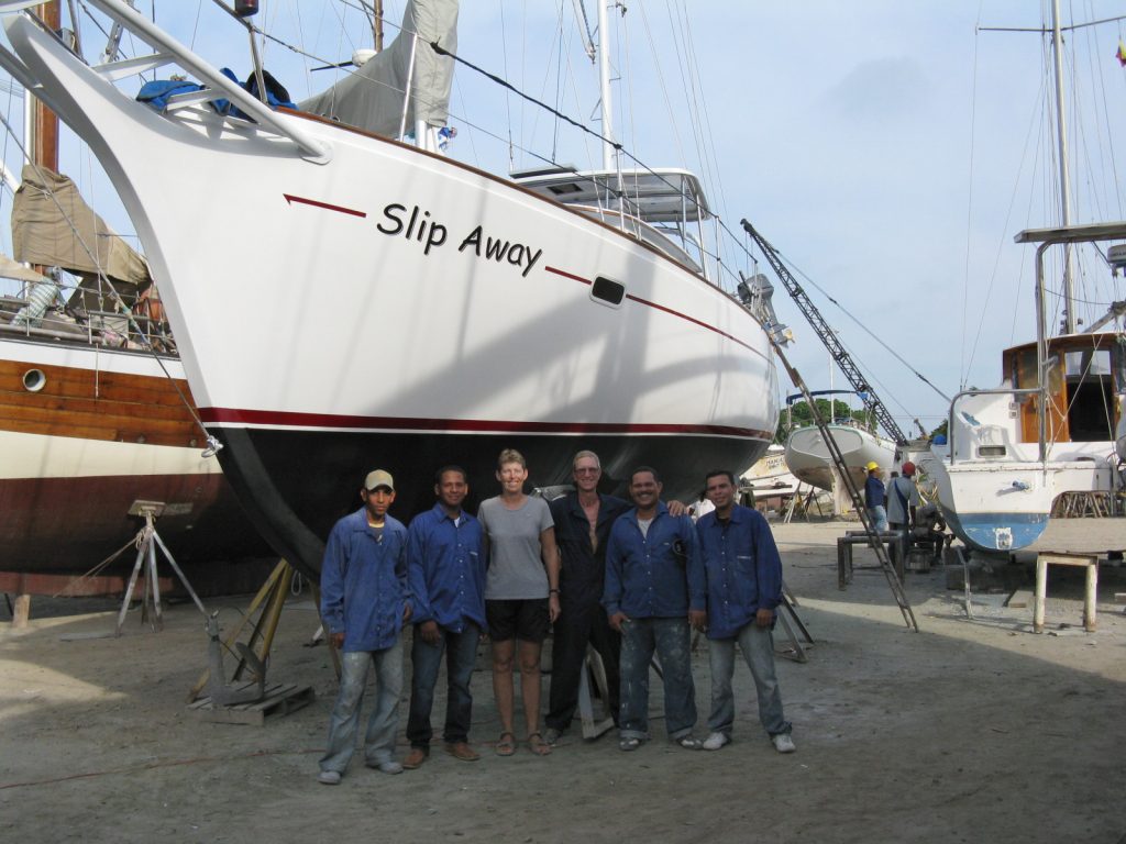 Jan and Rich (center) with Slip Away in 2009 and its painting crew in Cartagena, Colombia.