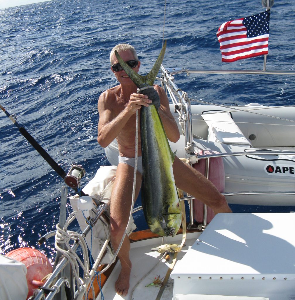 Rich on Slip Away with a mahi-mahi he caught in the South Pacific.